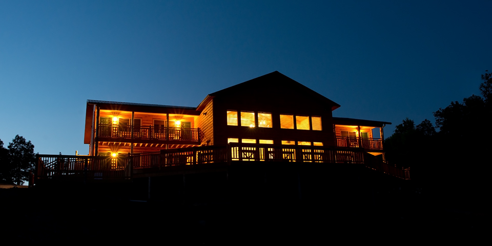 RiverWind Lodge glows at night over Buffalo River country