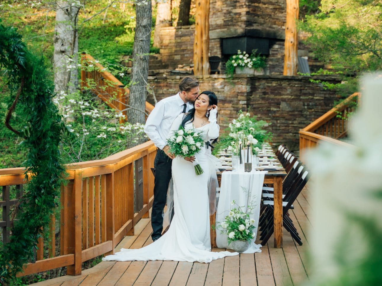 A wedding couple on the back deck. The beautiful exterior of the Ponca Creek Lodge makes it a great location for outdoor weddings and receptions